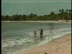 Couple having anal sex on the beach.